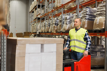 Image showing man on forklift loading cargo at warehouse