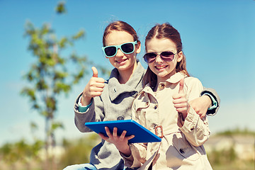 Image showing happy girls with tablet pc showing thumbs up