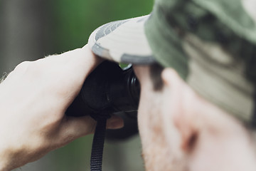 Image showing close up of soldier or hunter with binocular