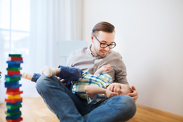 Image showing father and son playing and having fun at home