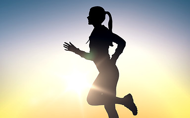 Image showing happy young sports woman running outdoors