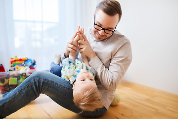 Image showing father and son playing and having fun at home