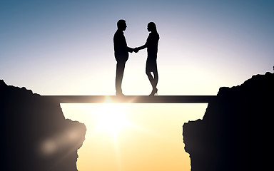 Image showing business partners silhouettes shaking hands