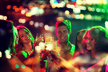 Image showing smiling friends with glasses of champagne in club