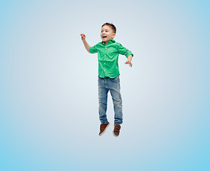 Image showing happy little boy jumping in air