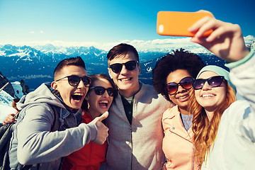 Image showing smiling friends taking selfie with smartphone