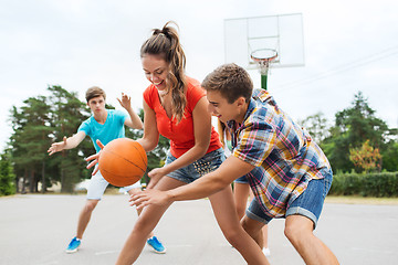 Image showing group of happy teenagers playing basketball