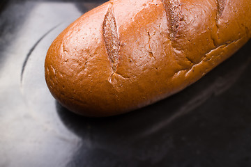 Image showing baking fresh bread in the bakehouse