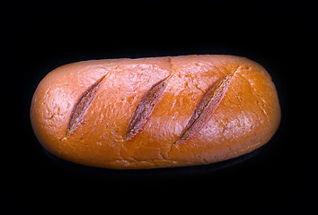 Image showing Large loaf of bread isolated on black