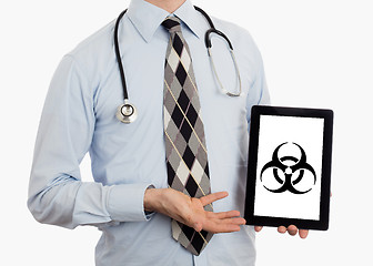 Image showing Doctor holding tablet - Warning! Biohazard!