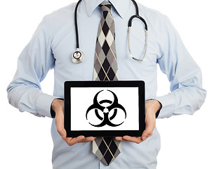 Image showing Doctor holding tablet - Warning! Biohazard!