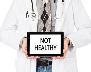 Image showing Doctor holding tablet - Not healthy
