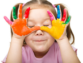 Image showing Portrait of a cute girl playing with paints