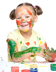 Image showing Portrait of a cute girl playing with paints