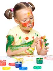 Image showing Portrait of a cute girl playing with paints