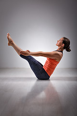 Image showing Woman practices yoga asana Paripurna navasana