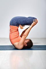 Image showing Woman practices inverted yoga asana