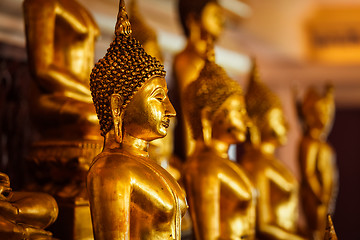 Image showing Golden Buddha statues in buddhist temple