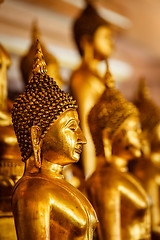 Image showing Golden Buddha statues in buddhist temple