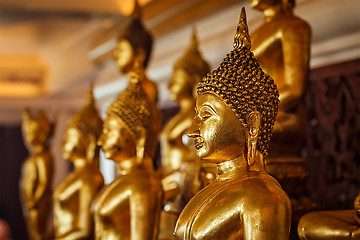 Image showing Golden Buddha statues in buddhist temple