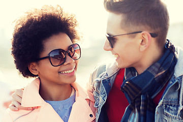 Image showing happy teenage friends in shades talking outdoors