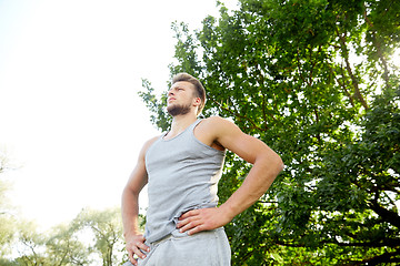 Image showing sporty young man with crossed arms at summer park