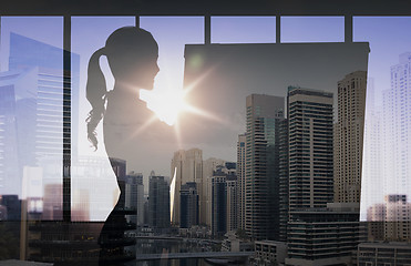 Image showing silhouette of woman with flipboard over city