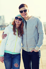 Image showing happy teenage couple walking in city