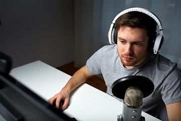 Image showing man in headset playing computer video game at home