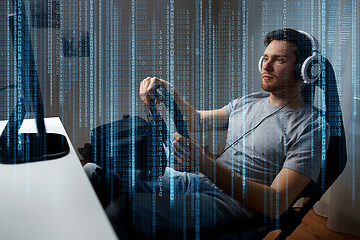 Image showing man playing car racing video game at home