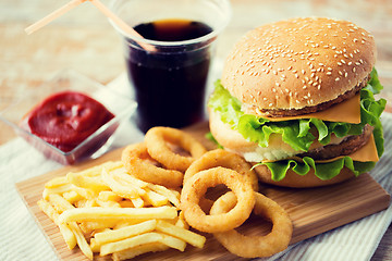 Image showing close up of fast food snacks and drink on table