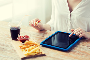 Image showing close up of woman with tablet pc and fast food