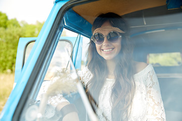 Image showing smiling young hippie woman in minivan car