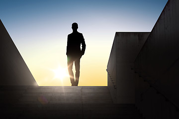 Image showing silhouette of businessman over sun light