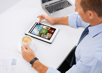 Image showing businessman with tablet pc and coffee in office