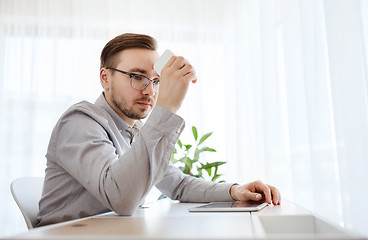 Image showing businessman with smarphone at home office