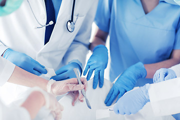 Image showing young group of doctors doing operation