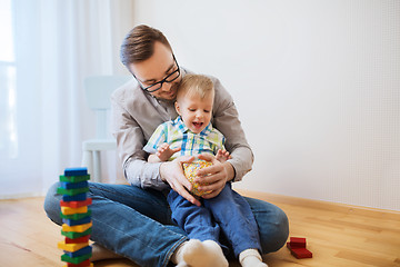 Image showing father and son playing with ball clay at home