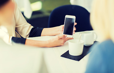 Image showing close up of women with smartphone at restaurant