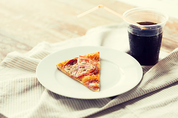 Image showing close up of pizza with coca cola on table