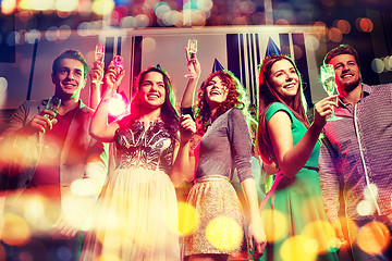 Image showing smiling friends with glasses of champagne in club