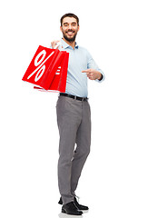 Image showing smiling man with red shopping bag