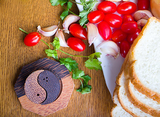 Image showing top-view of a wood table with olives tomatoes bread