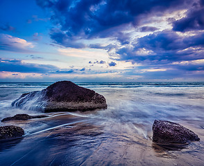 Image showing waves and rocks on beach of sunset