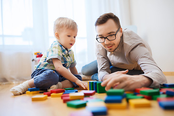 Image showing father and son playing with toy blocks at home