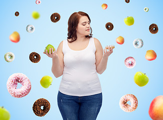 Image showing young plus size woman choosing apple or donut