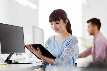 Image showing happy creative female office worker with tablet pc