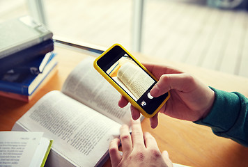 Image showing student hands with smartphone making cheat sheet