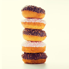 Image showing close up of glazed donuts pile over white