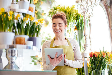 Image showing woman with tablet pc computer at flower shop